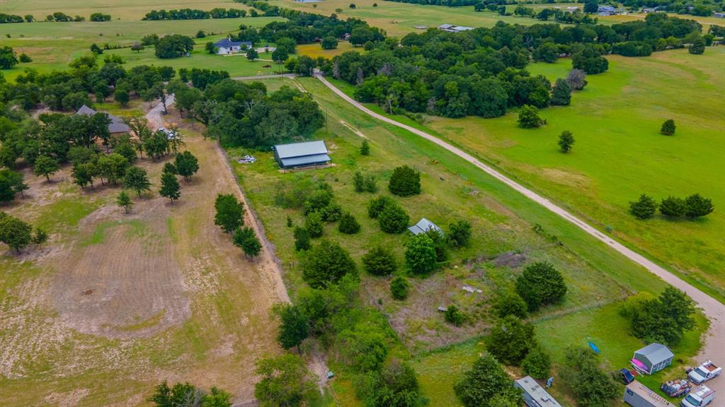 Tbd Wiggins Road West, TX 76691 - Photo 9 of 11 Expansive acreage featuring a private road, mature trees, open fields, and additional outbuildings