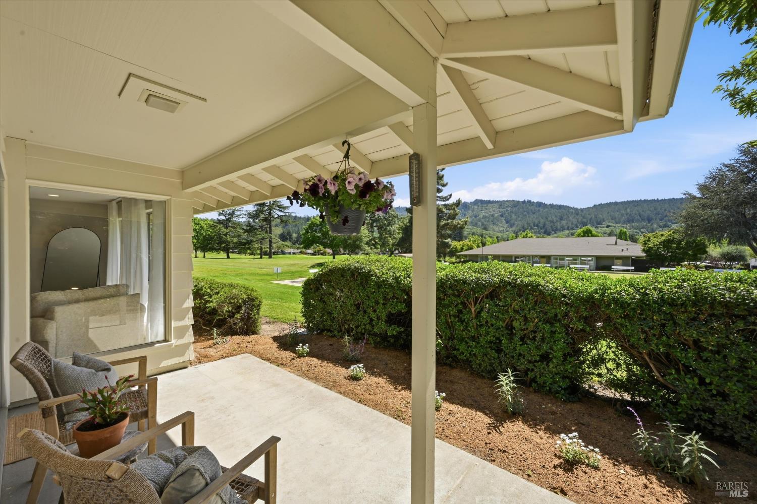 23 Valley Green Street Santa Rosa, CA 95409 - Photo 18 of 58 a view of a patio with table and chairs under an umbrella