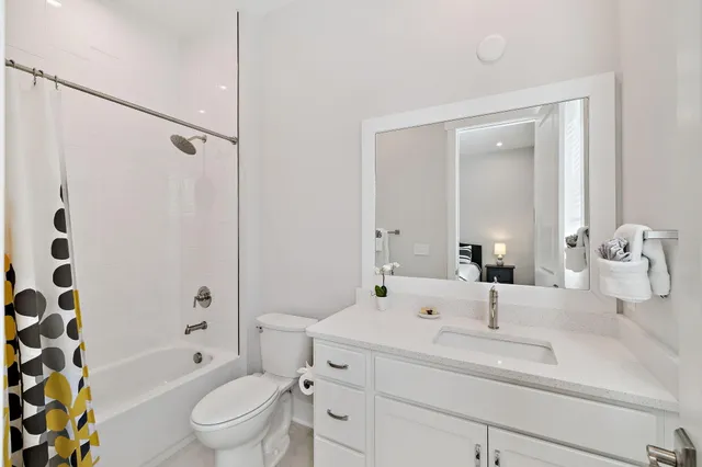 a kitchen with stainless steel appliances kitchen island granite countertop a table chairs in it and wooden floors