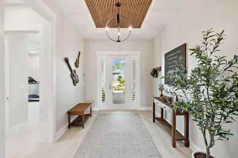 a kitchen with stainless steel appliances a dining table chairs and chandelier