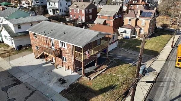 an aerial view of a house with a ocean view