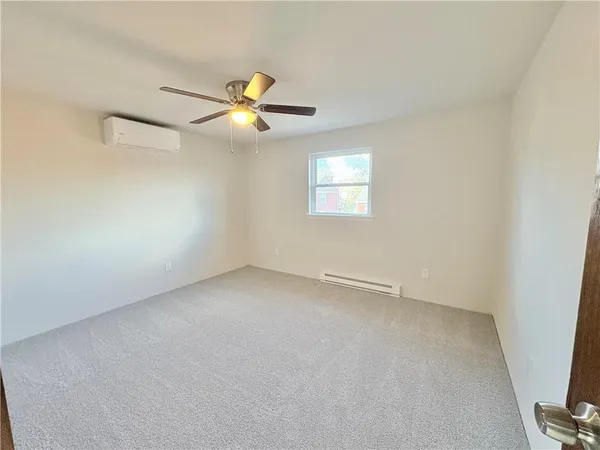 a view of a livingroom with a ceiling fan and wooden floor