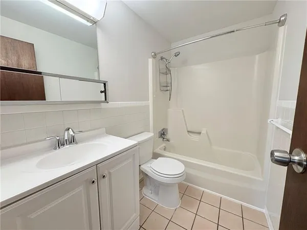 a bathroom with a sink a toilet and tub