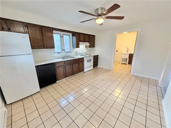 a kitchen with stainless steel appliances a sink and a refrigerator