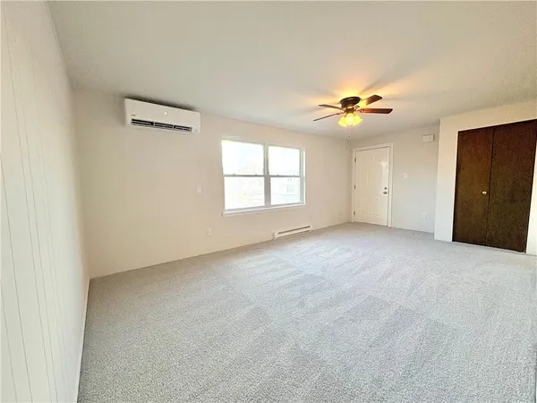 a view of a livingroom with a ceiling fan and window