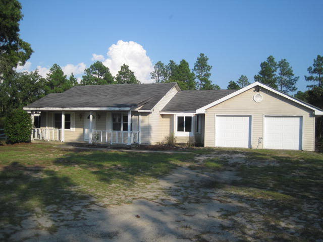 1256 Hamlin Road Lizella, GA 31052 - Photo 1 of 15 a front view of a house with a yard