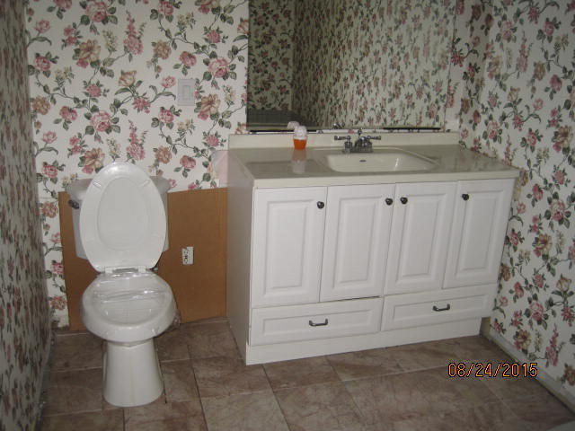 1256 Hamlin Road Lizella, GA 31052 - Photo 15 of 15 a bathroom with a granite countertop toilet and a sink