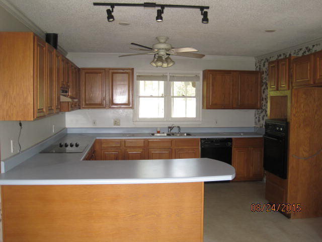 1256 Hamlin Road Lizella, GA 31052 - Photo 5 of 15 a kitchen with a sink a counter top space cabinets and stainless steel appliances