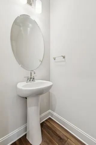 a bathroom with a sink a mirror and a toilet