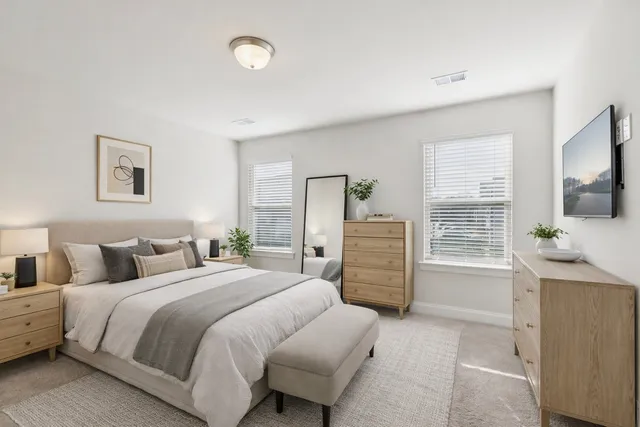 a spacious bedroom with a bed and a desk