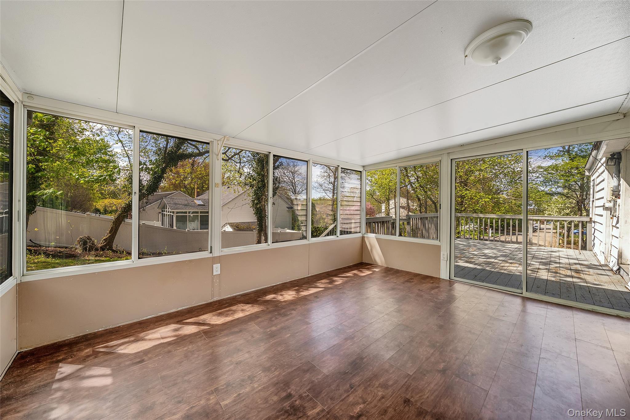 93 Maple Road Kings Park, NY 11754 - Photo 22 of 24 an empty room with wooden floor and windows