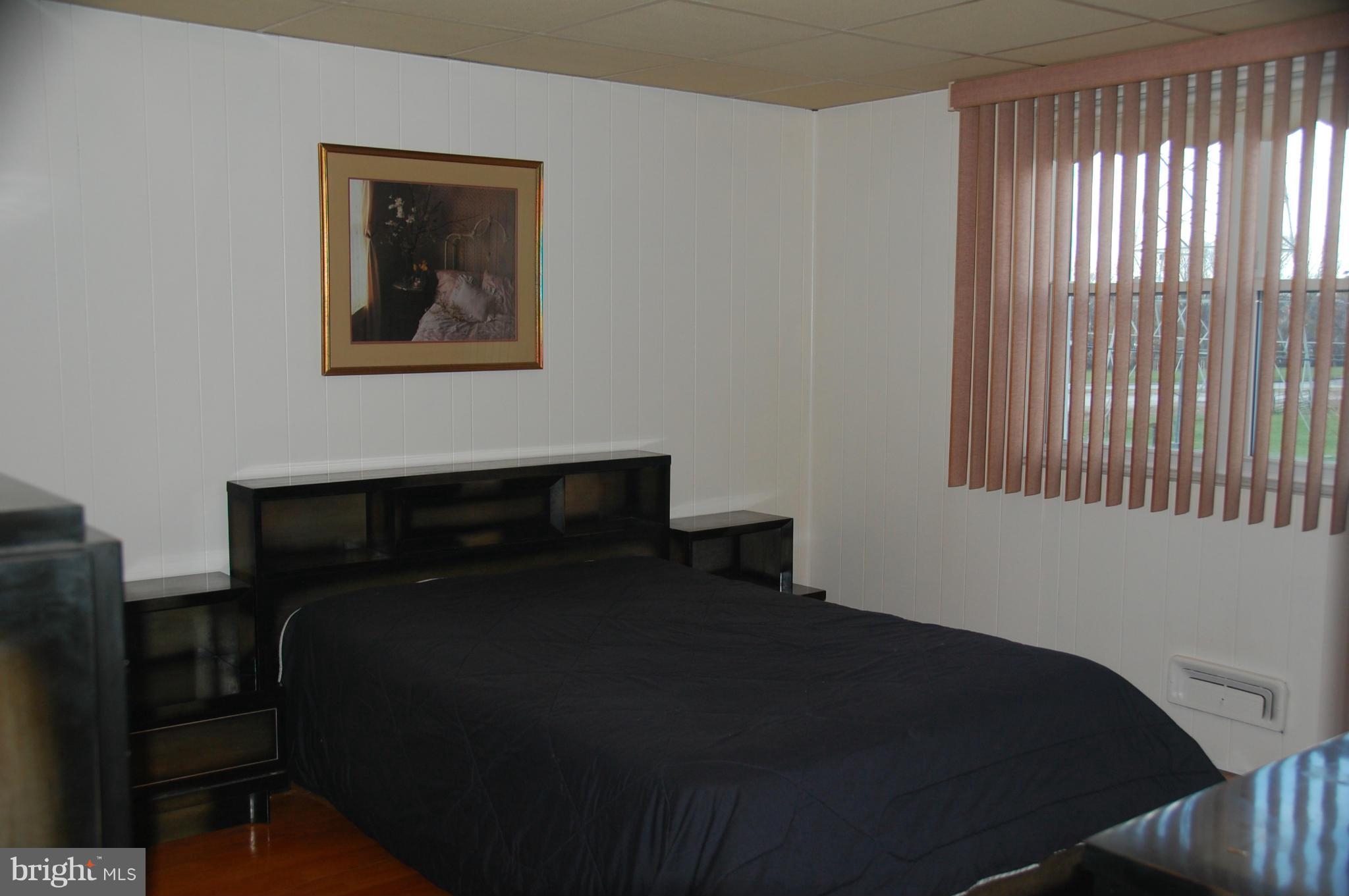1928 Church Road Dundalk, MD 21222 - Photo 11 of 18 a bedroom with a bed and a window