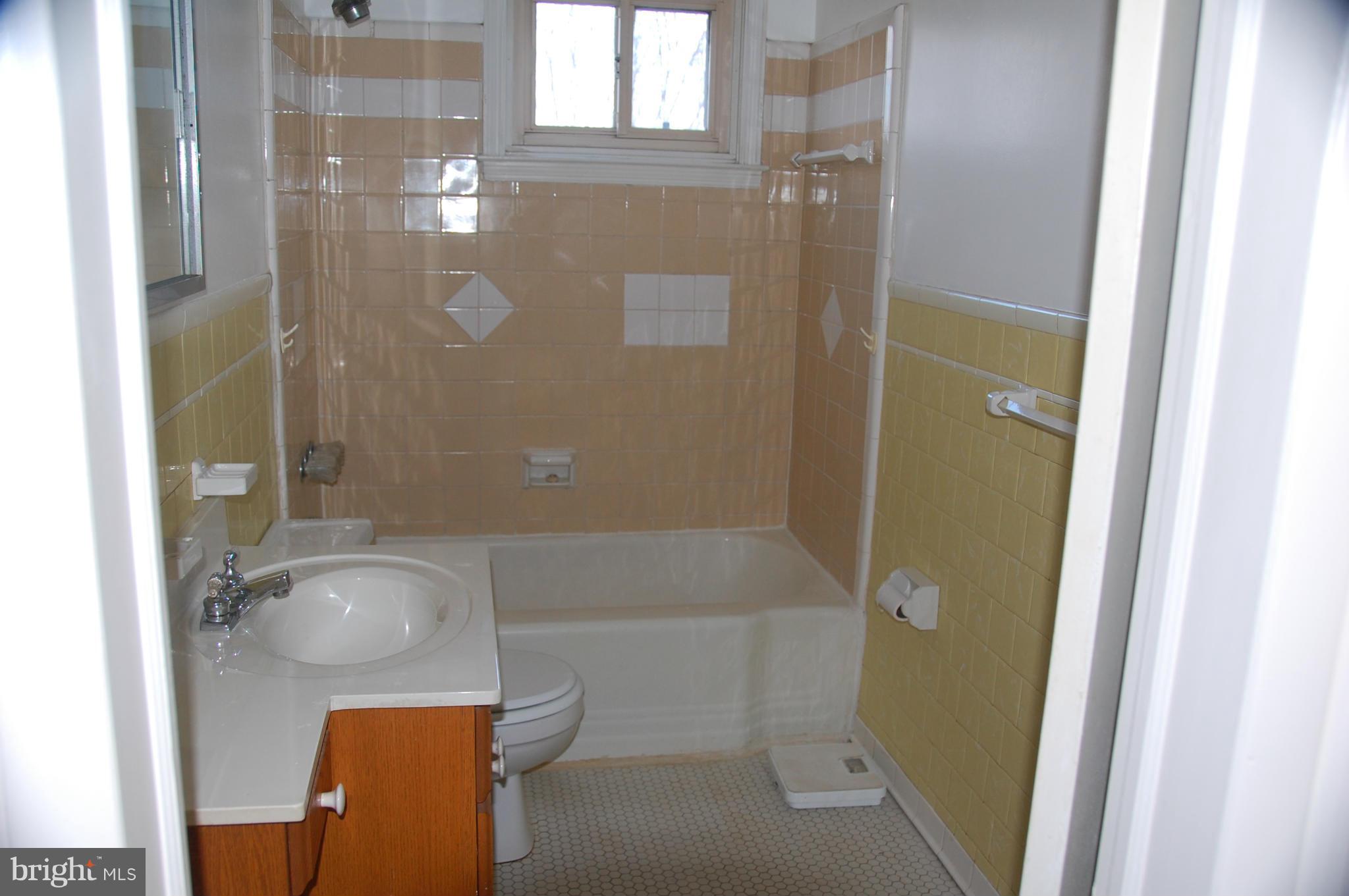 1928 Church Road Dundalk, MD 21222 - Photo 12 of 18 a bathroom with a granite countertop bathtub shower and toilet