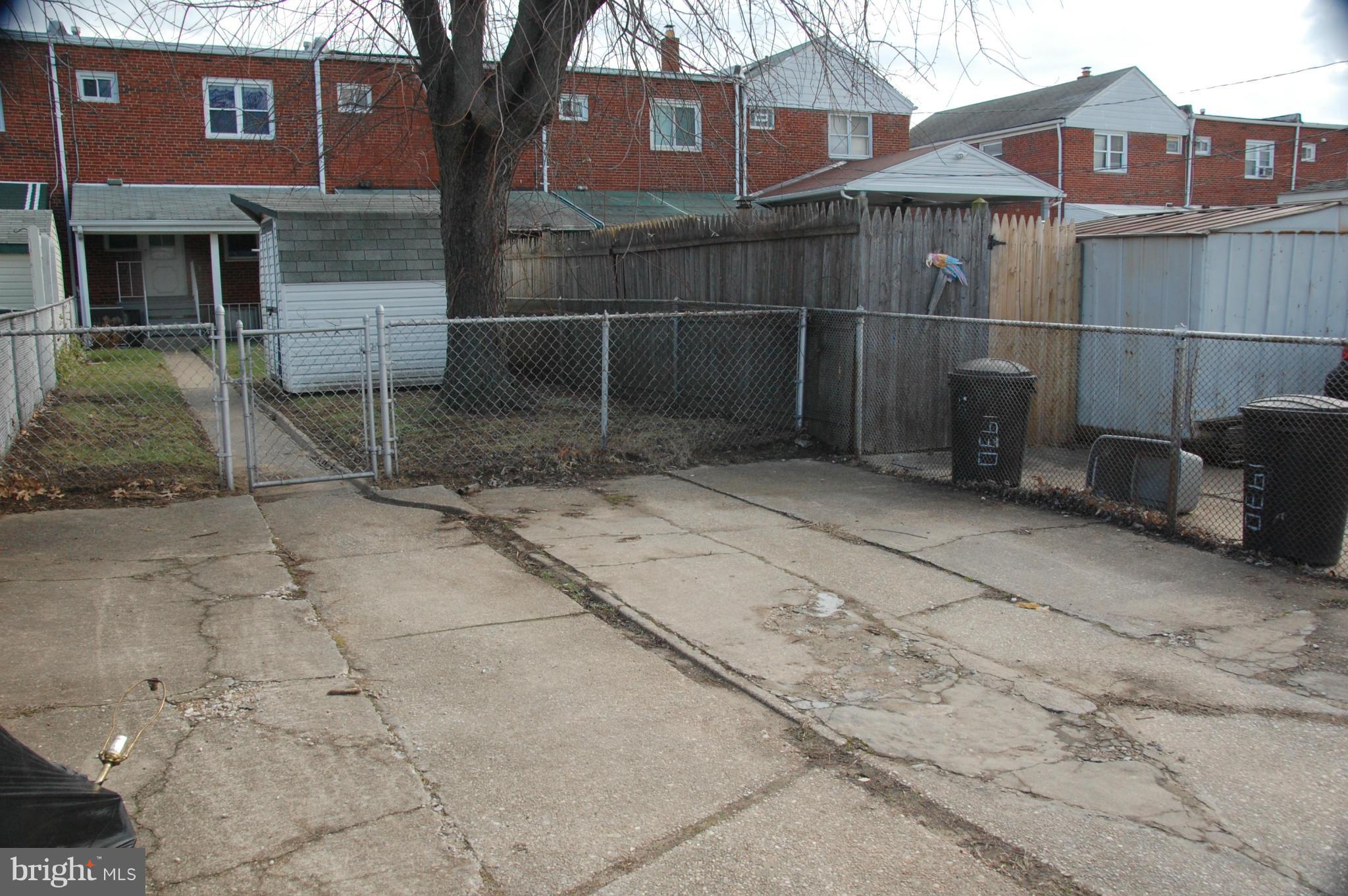 1928 Church Road Dundalk, MD 21222 - Photo 17 of 18 a backyard of a house with barbeque oven and a table and chairs