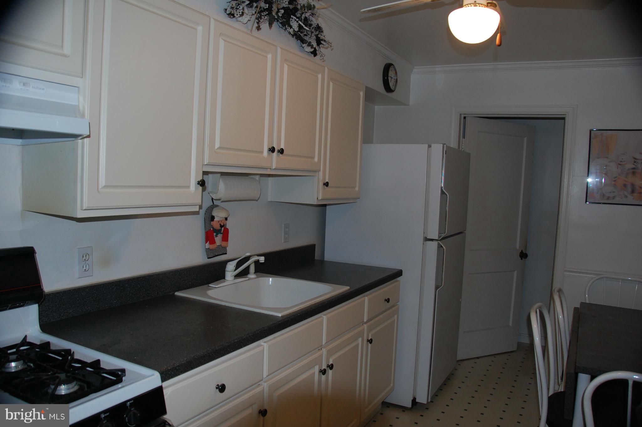 1928 Church Road Dundalk, MD 21222 - Photo 4 of 18 a kitchen with stainless steel appliances granite countertop a sink stove and refrigerator