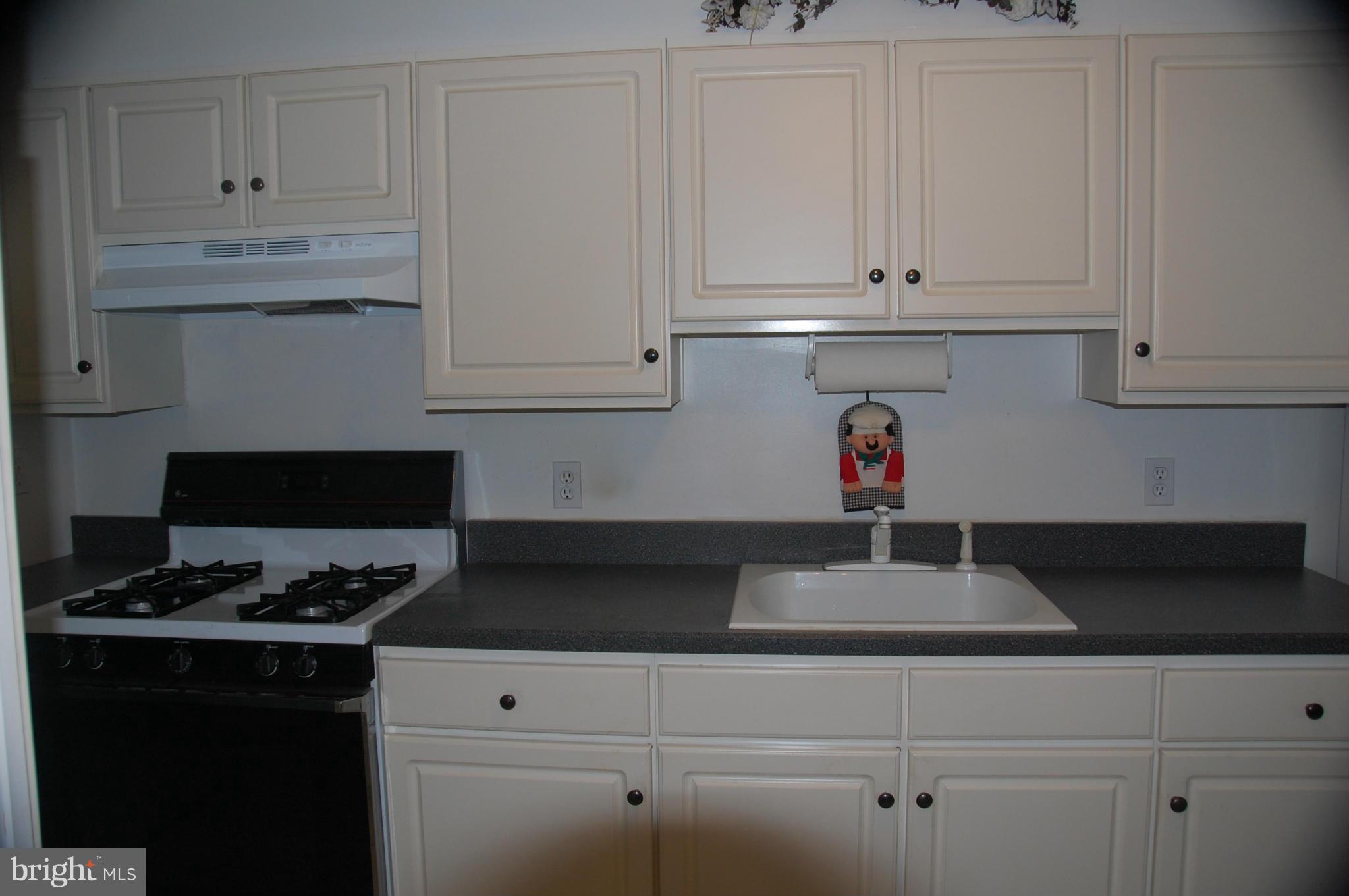 1928 Church Road Dundalk, MD 21222 - Photo 5 of 18 a kitchen with white cabinets and a stove