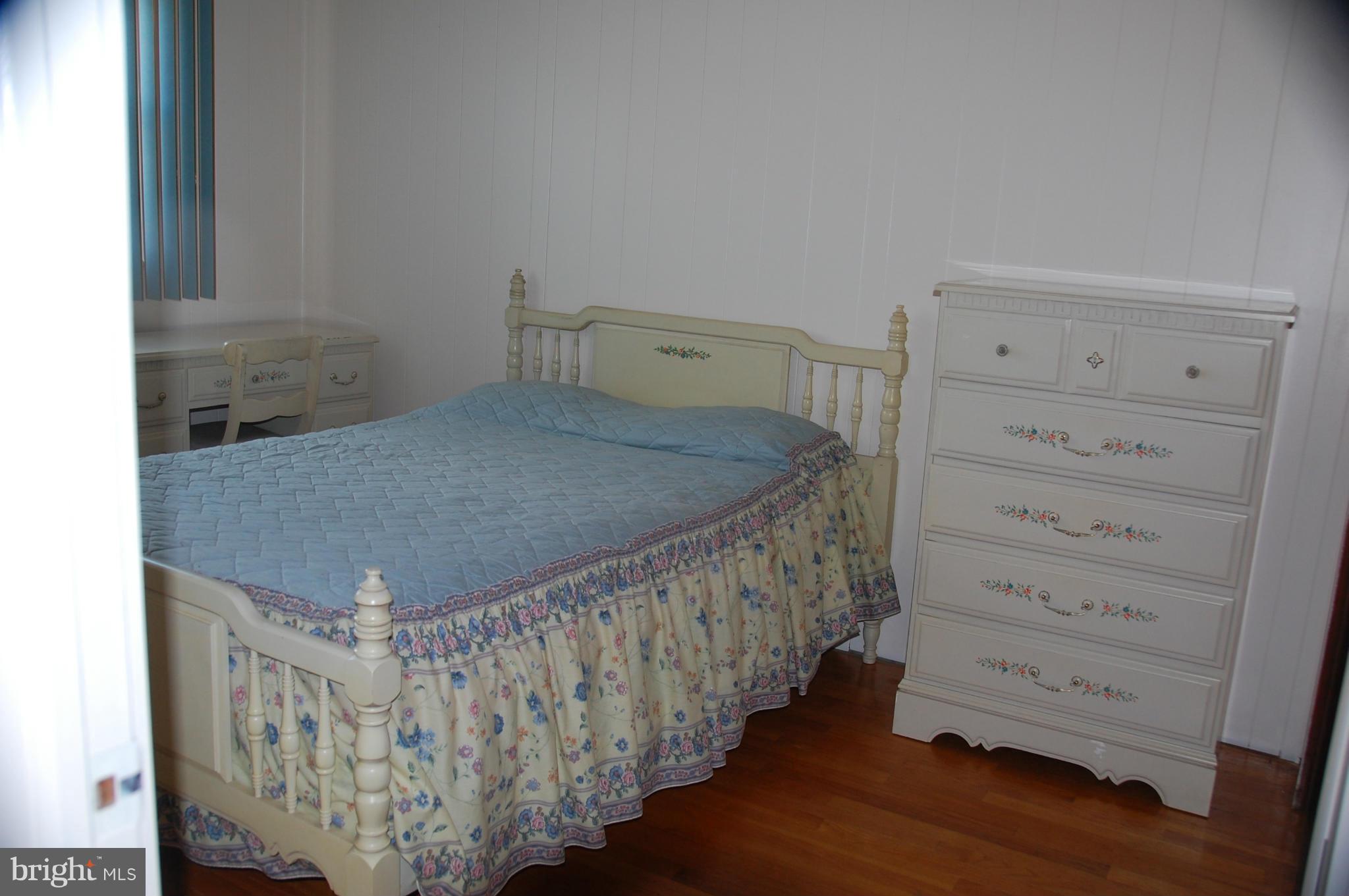 1928 Church Road Dundalk, MD 21222 - Photo 8 of 18 a bed sitting in a room next to a window