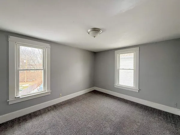 a view of an empty room and a window