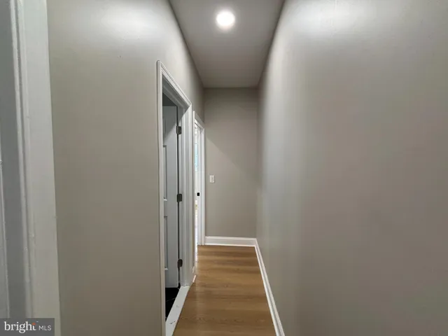 a view of hallway with wooden floor
