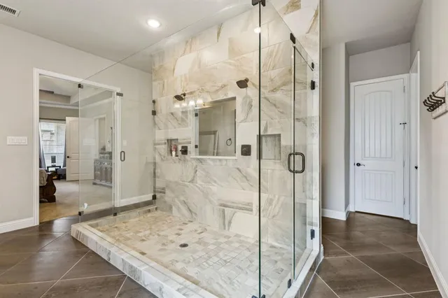 a bathroom with a granite countertop sink mirror and shower