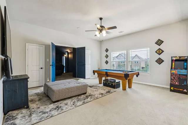 a living room with furniture a flat screen tv and a table