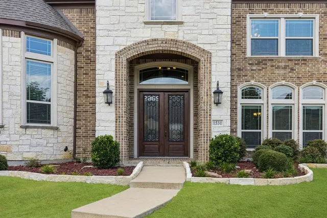 a front view of a house with garden