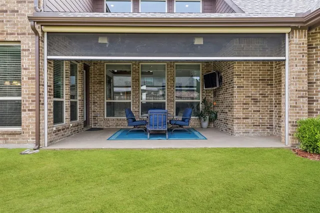 a view of a house with patio and a garden