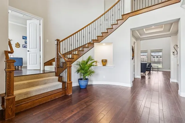 a view of entryway with wooden floor and stairs