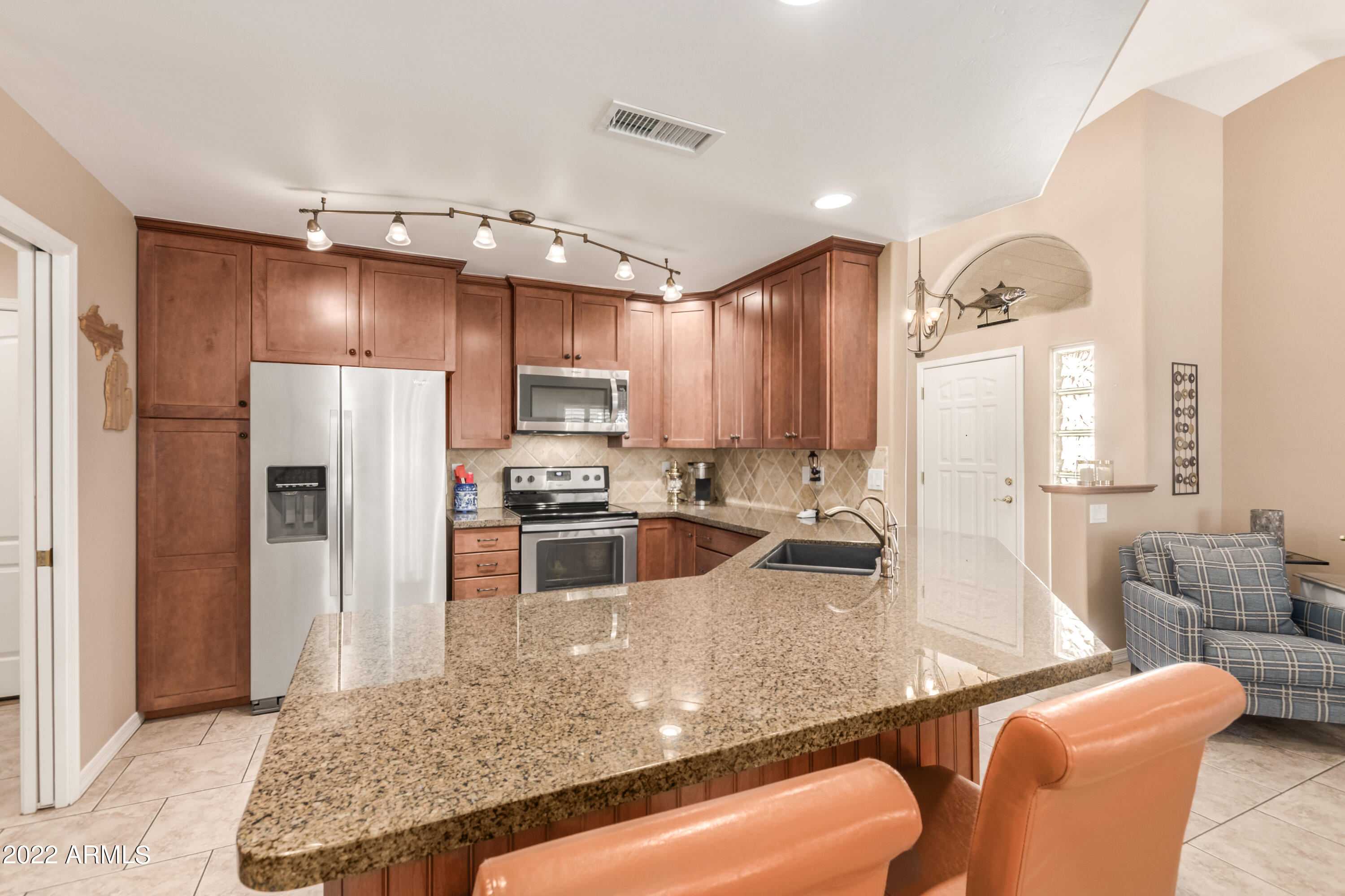 5830 East McKellips Road, Unit 76 Mesa, AZ 85215 - Photo 8 of 33 a kitchen with stainless steel appliances granite countertop a refrigerator a oven and white cabinets