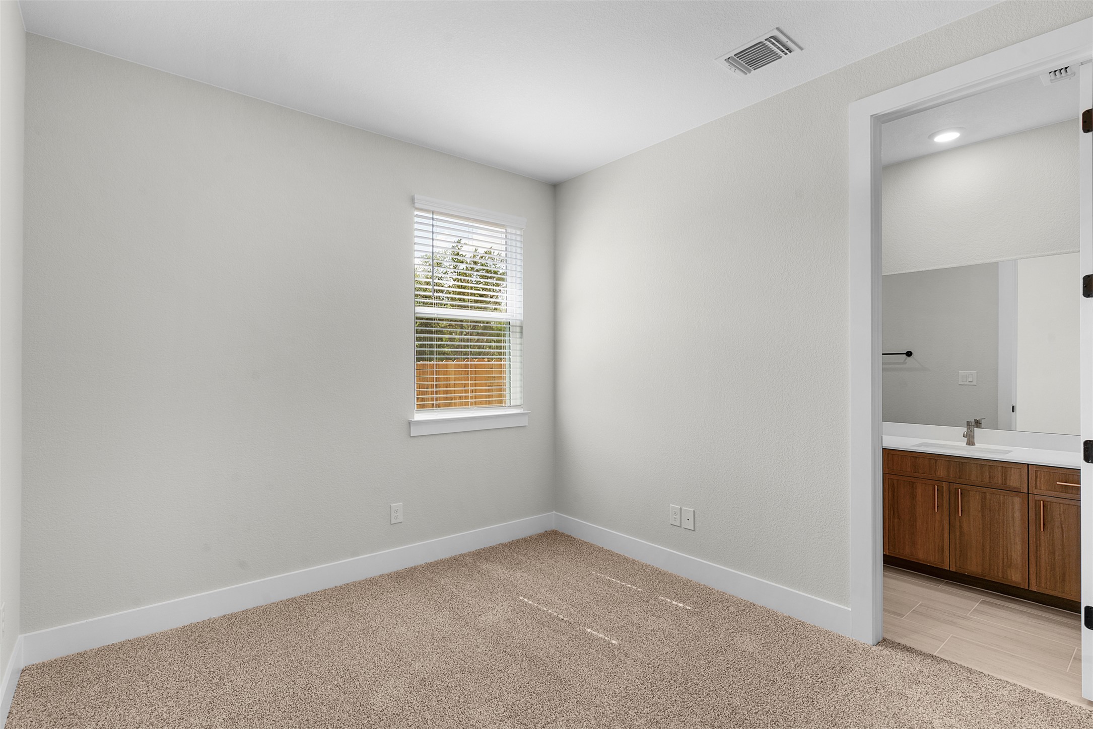 1121 Pansy Trail Georgetown, TX 78628 - Photo 6 of 25 Unfurnished bedroom featuring light carpet and ensuite bath
