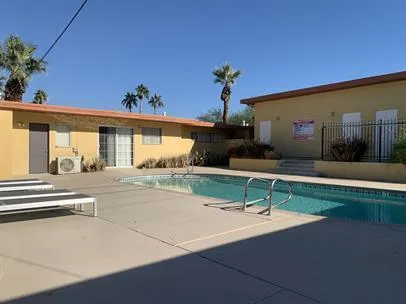 a view of a house with a swimming pool and a yard