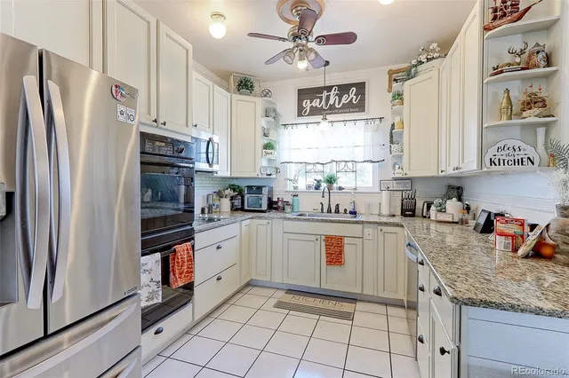 a kitchen with stainless steel appliances granite countertop a refrigerator sink and cabinets