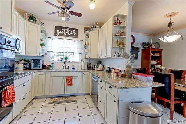 a kitchen with stainless steel appliances granite countertop a sink stove and cabinets