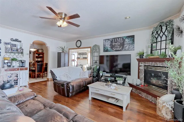 a living room with furniture a flat screen tv and a fireplace