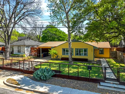 a front view of a house with a yard table and chairs