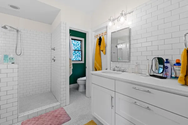 a bathroom with a sink a toilet and shower