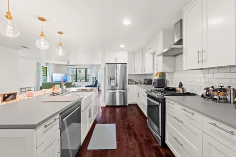 a kitchen with refrigerator a stove and cabinets
