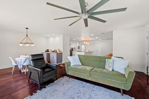 a living room with furniture and a wooden floor