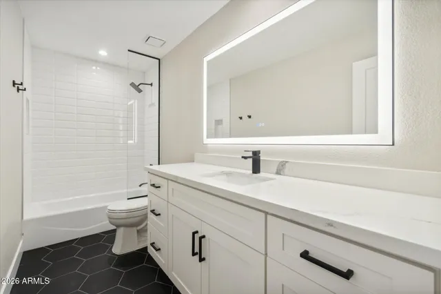 an empty room with wooden floor ceiling fan and window