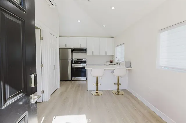 a kitchen with a sink cabinets and stainless steel appliances