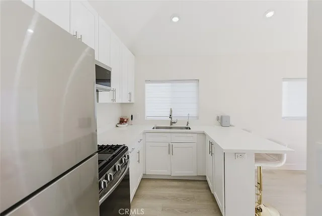 a kitchen with a sink stove and cabinets