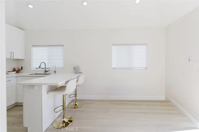 a kitchen with a sink cabinets and wooden floor