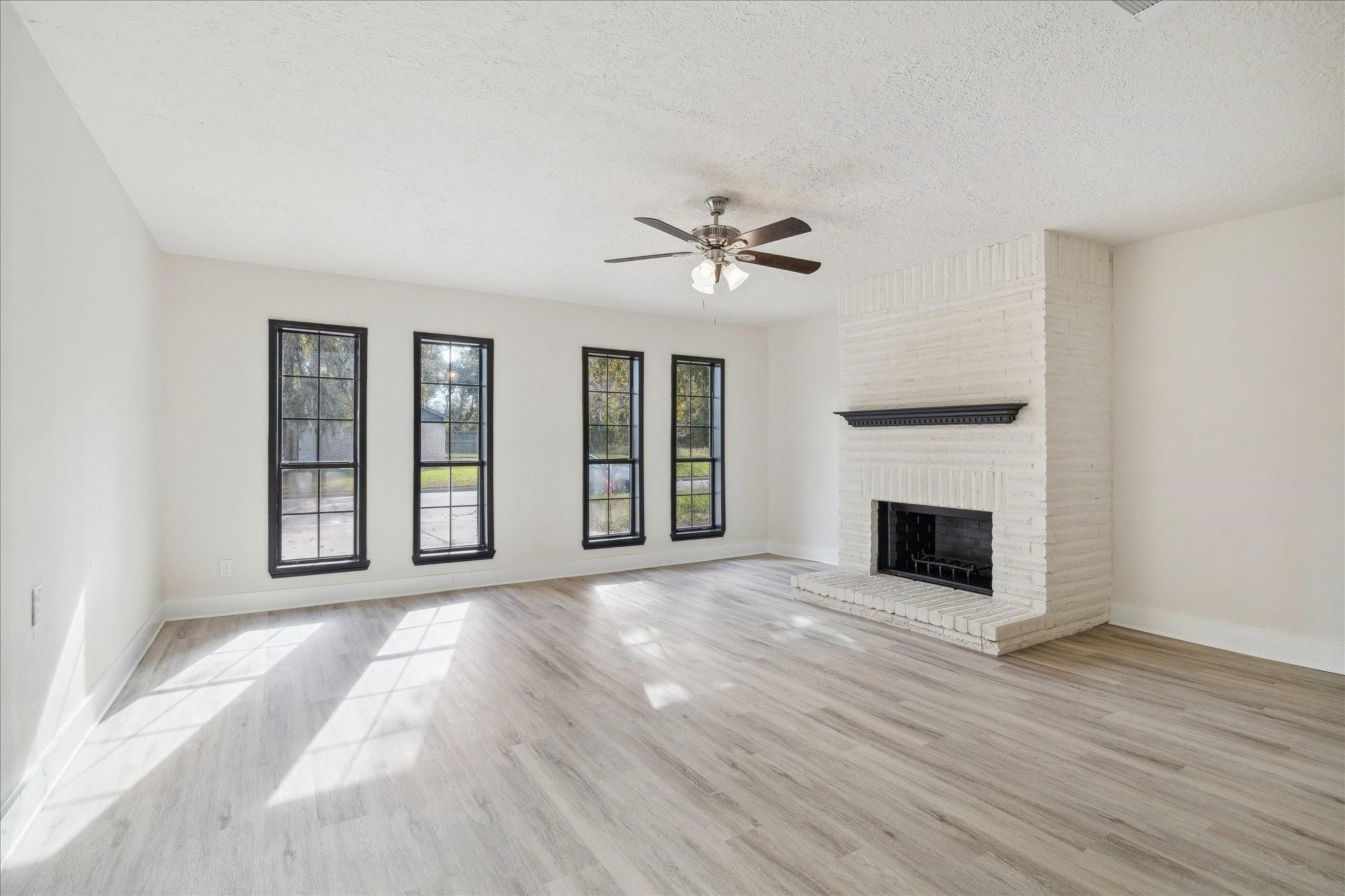 5515 Knightwood Street Houston, TX 77016 - Photo 2 of 11 a view of an empty room with a fireplace and a window