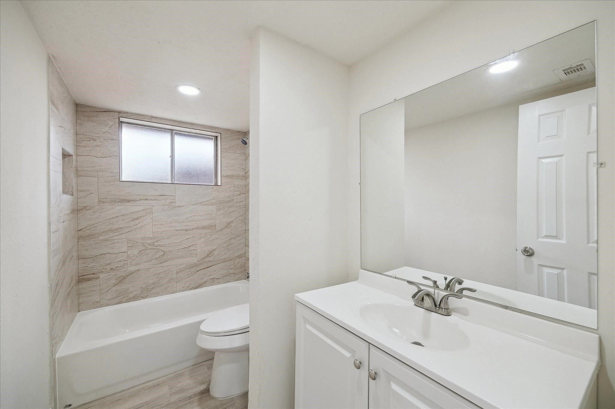 5515 Knightwood Street Houston, TX 77016 - Photo 9 of 11 a bathroom with a sink toilet and shower