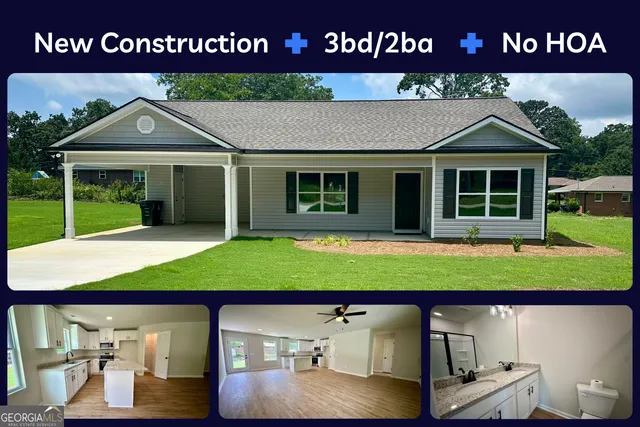 a view of a house with a small yard and large tree