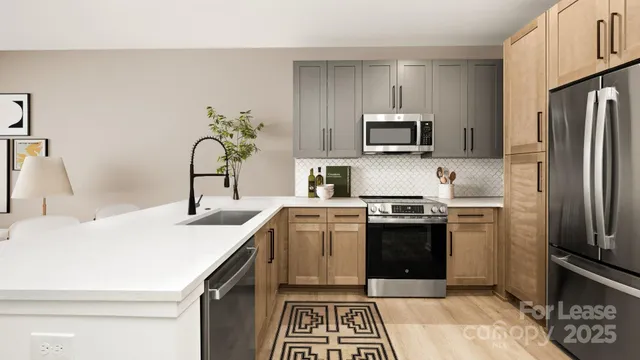 a kitchen with sink a microwave and cabinets