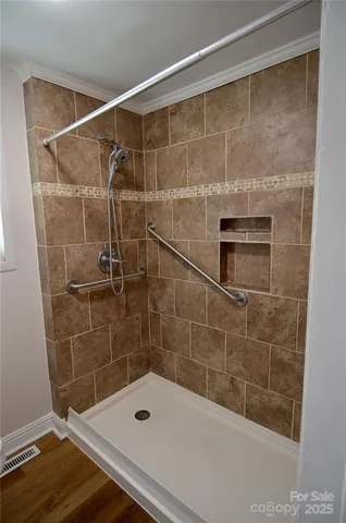 a bathroom with a shower and a sink