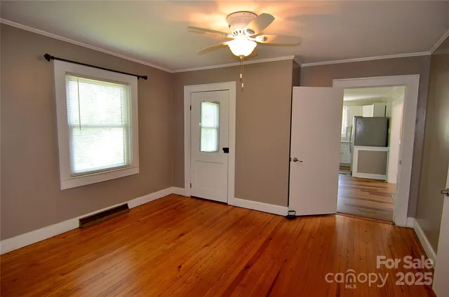 wooden floor in an empty room with a window