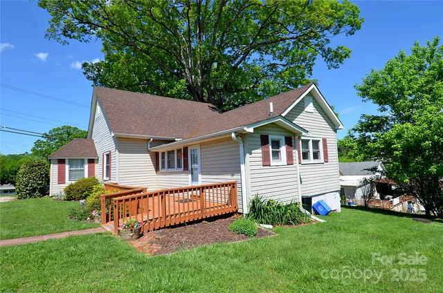 a front view of a house with a yard and trees