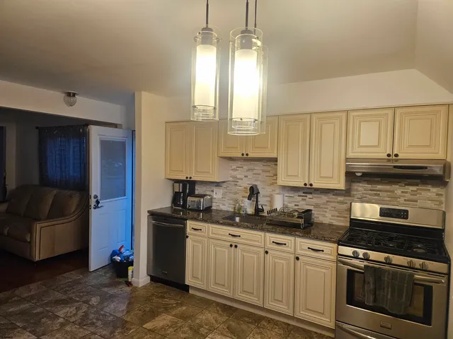 a kitchen with a sink stove and cabinets